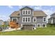 Exterior back of house showcasing a well manicured lawn with a deck and hot tub at 19405 Titus Dr, Westfield, IN 46074