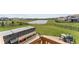 Expansive backyard featuring a well-maintained lawn, hot tub, and scenic view of the neighborhood pond at 19405 Titus Dr, Westfield, IN 46074