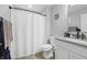 Neutral bathroom with white shower curtain, gray walls and wood look flooring at 19405 Titus Dr, Westfield, IN 46074