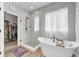 Modern bathroom featuring a standalone tub, glass enclosed shower, and walk-in closet at 19405 Titus Dr, Westfield, IN 46074