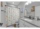 Compact bathroom with a single sink, modern fixtures, and shower with colorful curtain at 19405 Titus Dr, Westfield, IN 46074