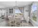 Bright dining room featuring stylish furniture, elegant decor, and access to beautiful views of the lake and backyard at 19405 Titus Dr, Westfield, IN 46074