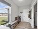 Inviting entryway with bench seating, storage drawers and natural light from the window at 19405 Titus Dr, Westfield, IN 46074