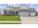 Charming single-story home with a three-car garage and well-manicured lawn at 19405 Titus Dr, Westfield, IN 46074