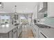 Bright kitchen with white cabinetry, stainless steel appliances, and quartz countertops, perfect for cooking at 19405 Titus Dr, Westfield, IN 46074