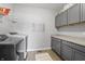 Functional laundry room features modern washer/dryer, cabinets, counter space and storage at 19405 Titus Dr, Westfield, IN 46074