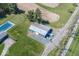 Aerial view of a large outbuilding with ample parking space and a home with an in-ground pool nearby at 19702 Tomlinson Rd, Westfield, IN 46074