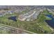 Aerial view of a home in a golf course community featuring ponds and lush landscaping; ideal for recreation at 19702 Tomlinson Rd, Westfield, IN 46074