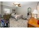 Cozy bedroom with ceiling fan, patterned rug, and comfortable decor at 19702 Tomlinson Rd, Westfield, IN 46074