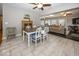Dining area featuring a table with white chairs, a ceiling fan, and open access to the living room at 19702 Tomlinson Rd, Westfield, IN 46074