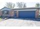 Charming brick home featuring a blue garage door and well-maintained landscaping at 19702 Tomlinson Rd, Westfield, IN 46074
