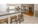 Bright kitchen with a granite island and wooden stools, flowing into the living room at 19702 Tomlinson Rd, Westfield, IN 46074