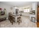 White kitchen featuring a granite island with seating, stainless steel appliances and bright countertops at 19702 Tomlinson Rd, Westfield, IN 46074