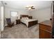 Primary bedroom with a ceiling fan, a king bed, carpeted floors, and a rocking chair at 19702 Tomlinson Rd, Westfield, IN 46074
