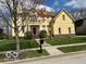 Welcoming home featuring a well-manicured lawn and a classic two-story design with a red front door at 1984 Telfair St, Carmel, IN 46032