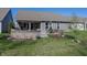 A backyard featuring a patio with seating, outdoor kitchen, and well-maintained lawn at 20133 Willenhall Way, Westfield, IN 46074