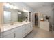 Bright bathroom features dual sinks, modern lighting, and a walk-in shower, offering a spa-like experience at 20133 Willenhall Way, Westfield, IN 46074