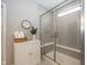 Elegant bathroom featuring a glass shower with built-in bench and stylish storage cabinet with greenery decor at 20133 Willenhall Way, Westfield, IN 46074