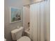 Well-lit bathroom with a decorative world map art piece above the toilet and a shower with a white curtain at 20133 Willenhall Way, Westfield, IN 46074