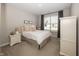 Cozy bedroom with a comfortable bed, soft pillows, bedside table, and large window offering natural light at 20133 Willenhall Way, Westfield, IN 46074