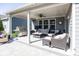A covered patio with comfortable seating, ceiling fan, and a stainless steel grill at 20133 Willenhall Way, Westfield, IN 46074