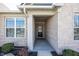 Inviting front entryway featuring brick accents and a covered porch, offering a warm welcome at 20133 Willenhall Way, Westfield, IN 46074