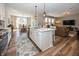 A spacious kitchen area, with a large island with sink and counter seating, is connected to the dining and living rooms at 20133 Willenhall Way, Westfield, IN 46074