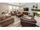Spacious living room with comfortable seating, a fireplace, and large windows that flood the space with light at 20133 Willenhall Way, Westfield, IN 46074
