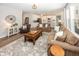 Bright and airy living space with a fireplace, hardwood floors, and an open design that connects to the kitchen at 20133 Willenhall Way, Westfield, IN 46074