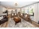 Open-concept living area with hardwood floors, comfortable seating, and a view into the modern kitchen at 20133 Willenhall Way, Westfield, IN 46074