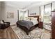 A sun-filled main bedroom features wood floors, a tray ceiling, and ample space for relaxation at 20133 Willenhall Way, Westfield, IN 46074