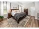 Primary bedroom boasts a comfortable bed, wood floors, and a window with natural light and stylish furniture at 20133 Willenhall Way, Westfield, IN 46074