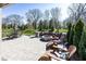 A spacious outdoor area with a fire pit, Adirondack chairs, and patio seating at 20133 Willenhall Way, Westfield, IN 46074