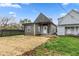 A compact grey bungalow with modern siding with a back entrance and a freshly seeded lawn at 2118 Lexington Ave, Indianapolis, IN 46203