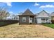 A charming grey bungalow with a freshly seeded backyard and modern siding with a back entrance at 2118 Lexington Ave, Indianapolis, IN 46203