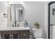 Bathroom featuring a vanity with marble countertop and a decorative mirror at 2118 Lexington Ave, Indianapolis, IN 46203
