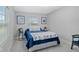 Cozy bedroom with a comfy bed, cute wall art, and natural light streaming in through the window at 2118 Lexington Ave, Indianapolis, IN 46203