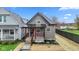 Charming home features a cozy front porch, gray siding, and freshly landscaped garden at 2118 Lexington Ave, Indianapolis, IN 46203
