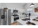 Modern kitchen featuring stainless steel appliances, white cabinets, and a bright white backsplash at 2118 Lexington Ave, Indianapolis, IN 46203
