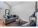Bright living room with high ceilings, a plush sofa, and a cozy decorative rug at 2118 Lexington Ave, Indianapolis, IN 46203
