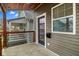 The porch of the house, featuring wood accents, a modern door, and a stylish mailbox at 2118 Lexington Ave, Indianapolis, IN 46203