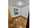 Cozy bedroom with wood-look floors, natural light, and textured ceiling at 213 Harrell Dr, Edinburgh, IN 46124