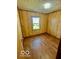 Cozy bedroom features wood-look flooring and natural light from a window at 213 Harrell Dr, Edinburgh, IN 46124