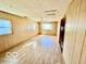 Open living room with ample natural light, laminate flooring, and neutral paint scheme at 213 Harrell Dr, Edinburgh, IN 46124