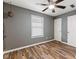 This bedroom features stylish wood floors, neutral gray walls, two closets, and a modern ceiling fan at 2511 Countryside Westview Dr, Shelbyville, IN 46176