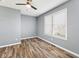 Bedroom with wood floors, a ceiling fan, and a large window provides plenty of light at 2511 Countryside Westview Dr, Shelbyville, IN 46176