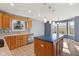 Open kitchen featuring wooden cabinets, a blue island, and stainless steel appliances at 2511 Countryside Westview Dr, Shelbyville, IN 46176
