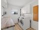 A spacious laundry room features a wooden countertop, cabinets, and a washer-dryer set at 2511 Countryside Westview Dr, Shelbyville, IN 46176