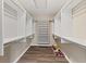 A walk-in closet with shelving, hanging rods, and wood floors offers ample storage at 2511 Countryside Westview Dr, Shelbyville, IN 46176