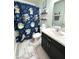 Fun bathroom with a 'Grogu' themed shower curtain, modern vanity, floating shelves, and stylish decor at 2936 W Calimanco Ln, Monrovia, IN 46157